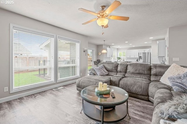 715 Shadowwood Loop, Keizer, OR 97303 - living area with light wood-style floors, ceiling fan, and recessed lighting