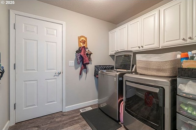 715 Shadowwood Loop, Keizer, OR 97303 - laundry area with cabinet space, separate washer and dryer, dark wood-type flooring, and a textured ceiling
