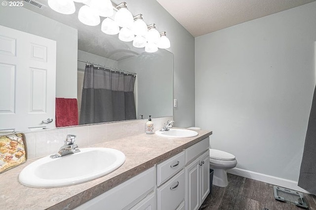 715 Shadowwood Loop, Keizer, OR 97303 - bathroom with wood finished floors, double vanity, curtained shower, and decorative backsplash
