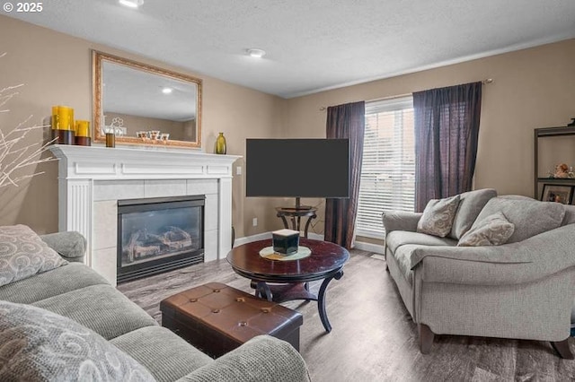 715 Shadowwood Loop, Keizer, OR 97303 - living room with wood finished floors, a tiled fireplace, and a textured ceiling