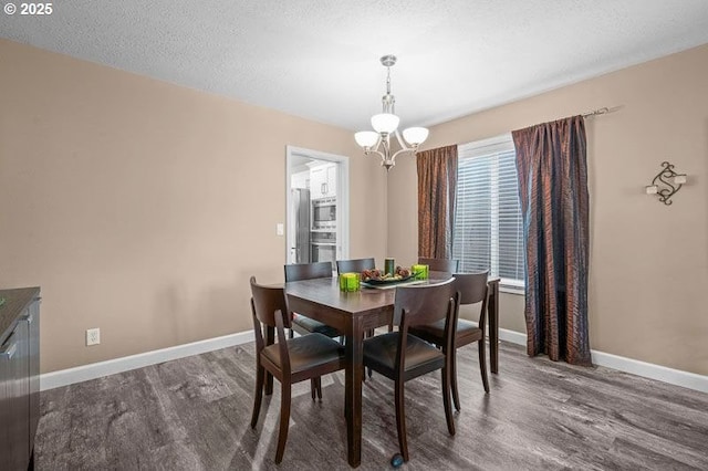 715 Shadowwood Loop, Keizer, OR 97303 - dining area featuring wood finished floors, a chandelier, and a textured ceiling