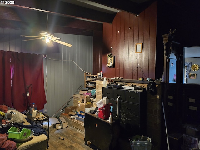 bedroom with ceiling fan, beam ceiling, and hardwood / wood-style floors