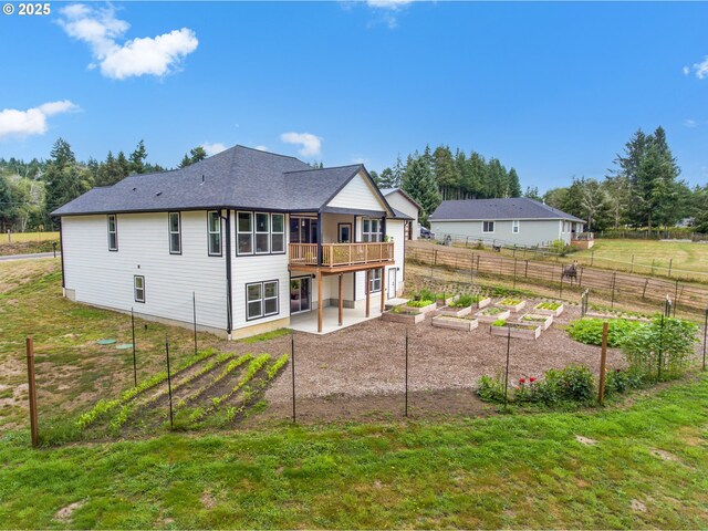 37330 Labiske Ln, Astoria, OR 97103 - rear view of house with a vegetable garden, a patio, and a deck