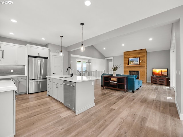 37330 Labiske Ln, Astoria, OR 97103 - kitchen with appliances with stainless steel finishes, a sink, light countertops, lofted ceiling, and light wood-style floors