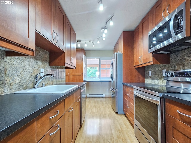 213 Oswego, Lake Oswego, OR 97035 - kitchen featuring appliances with stainless steel finishes, light wood-type flooring, a baseboard radiator, and brown cabinetry