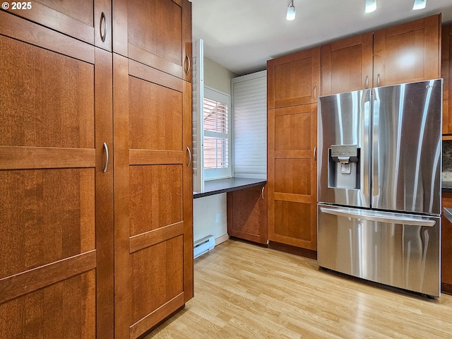 213 Oswego, Lake Oswego, OR 97035 - kitchen featuring stainless steel fridge with ice dispenser, baseboard heating, brown cabinets, and light wood-style floors