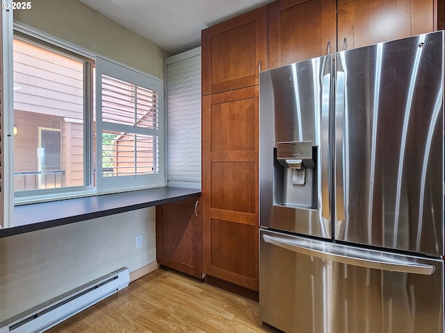 213 Oswego, Lake Oswego, OR 97035 - kitchen with stainless steel refrigerator with ice dispenser, a baseboard heating unit, light wood finished floors, brown cabinets, and dark countertops