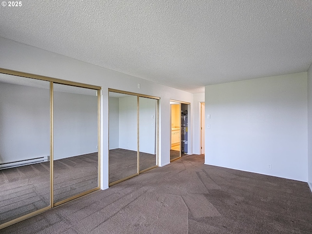 213 Oswego, Lake Oswego, OR 97035 - unfurnished bedroom with baseboard heating, carpet flooring, multiple closets, and a textured ceiling