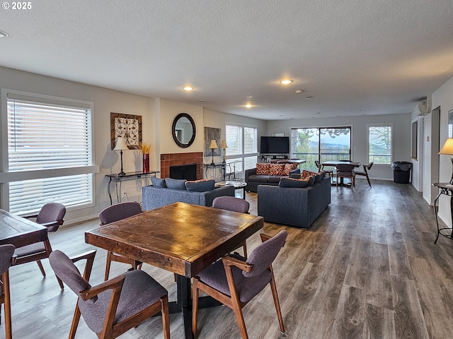 213 Oswego, Lake Oswego, OR 97035 - dining room featuring recessed lighting, wood finished floors, a textured ceiling, and a fireplace
