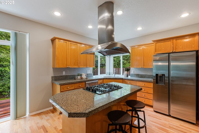 555 NE 58th Ave, Hillsboro, OR 97124 - kitchen featuring stainless steel appliances, island range hood, light wood-type flooring, a kitchen island, and recessed lighting