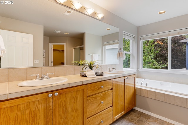 555 NE 58th Ave, Hillsboro, OR 97124 - bathroom featuring double vanity, a relaxing tiled tub, decorative backsplash, a shower, and recessed lighting