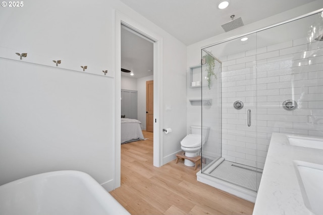 305 Fir Rd, Ariel, WA 98603 - ensuite bathroom featuring wood finished floors, a stall shower, recessed lighting, a freestanding tub, and toilet