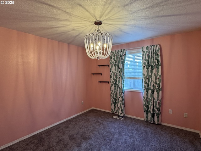 carpeted empty room featuring a chandelier, a textured ceiling, baseboards, and visible vents