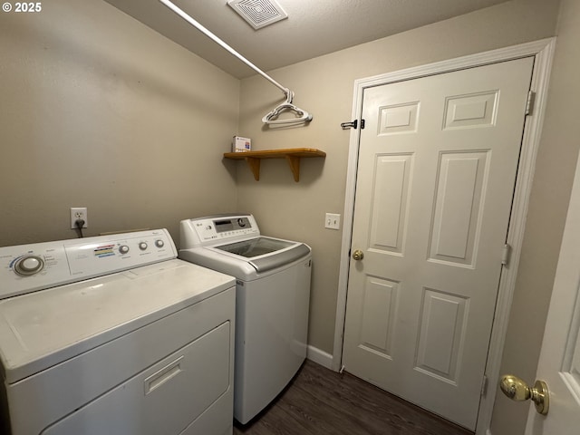 washroom with separate washer and dryer, baseboards, dark wood-style floors, visible vents, and laundry area