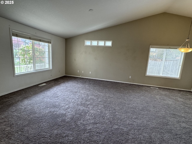unfurnished room featuring dark colored carpet, visible vents, baseboards, and lofted ceiling