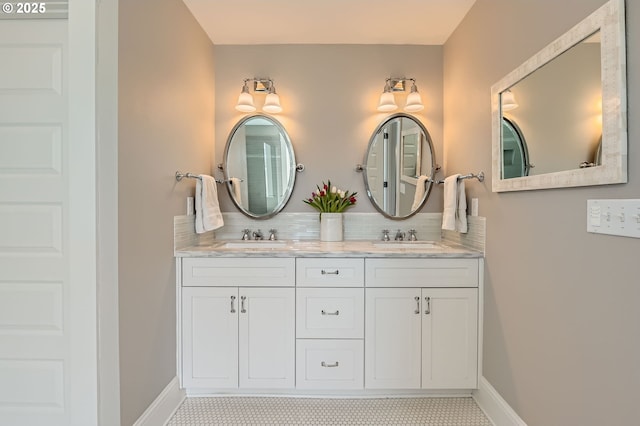 full bathroom with baseboards, a sink, and decorative backsplash