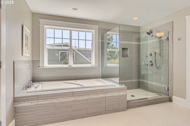 full bath featuring recessed lighting, a bath, baseboards, and a stall shower