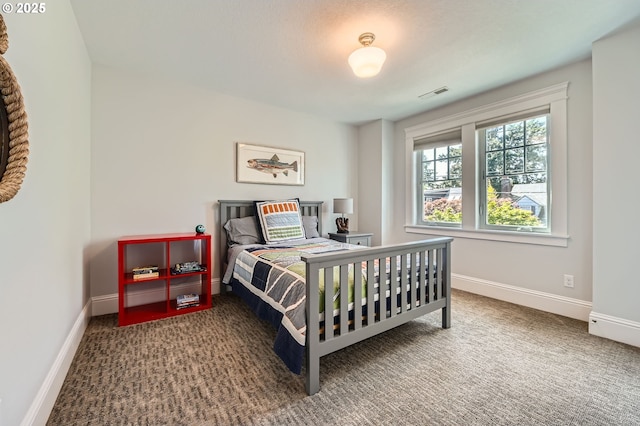 bedroom with baseboards, carpet floors, and visible vents