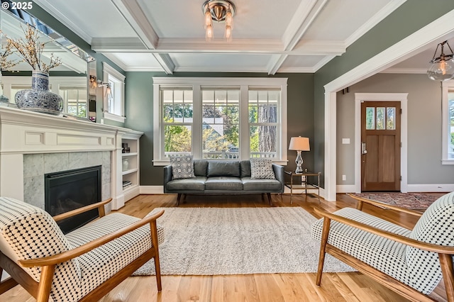 living room featuring baseboards, plenty of natural light, and wood finished floors