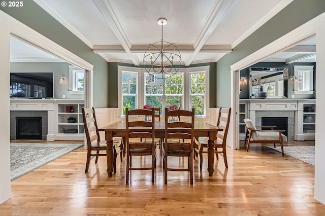 dining area with ornamental molding, a fireplace, and a notable chandelier