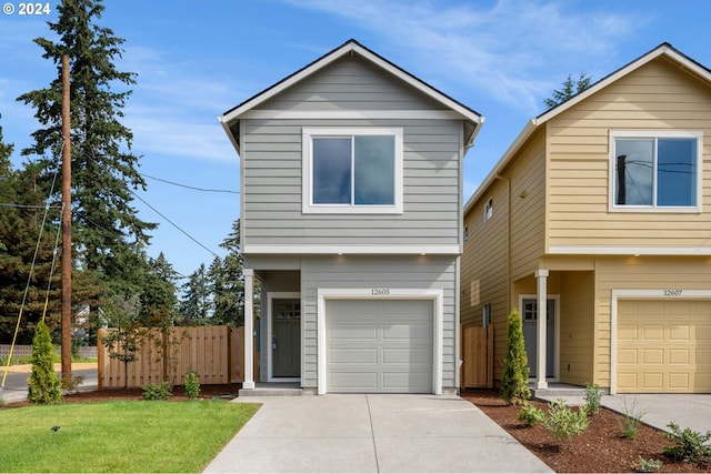 view of property featuring a front lawn and a garage