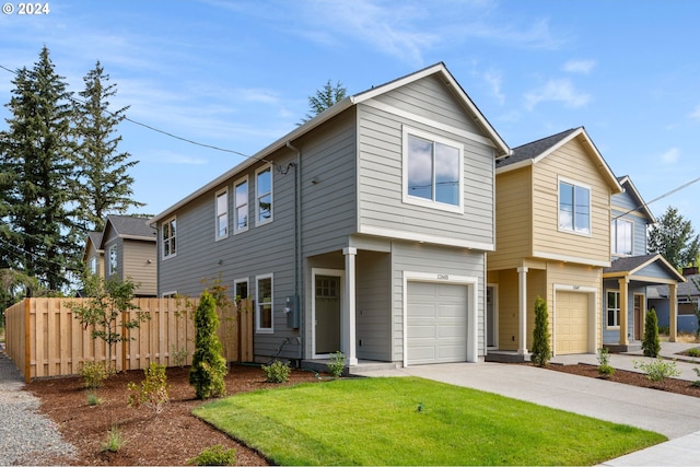 view of front of home featuring a front lawn and a garage