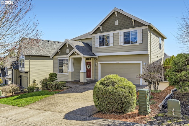 craftsman-style house with an attached garage and driveway