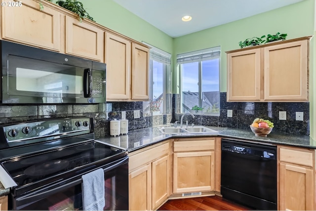 kitchen with black appliances, a sink, light brown cabinets, and recessed lighting