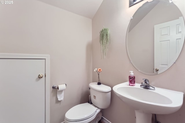 half bathroom with toilet and a sink