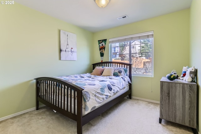 bedroom with light colored carpet and baseboards