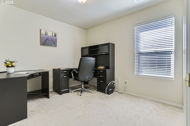 office with light colored carpet, baseboards, and healthy amount of natural light