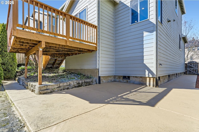 view of patio featuring a deck and stairs