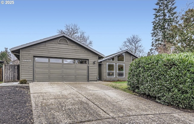 view of front of house featuring a garage and an outbuilding