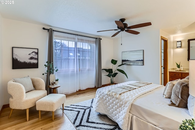 bedroom featuring ensuite bath, ceiling fan, and light hardwood / wood-style floors