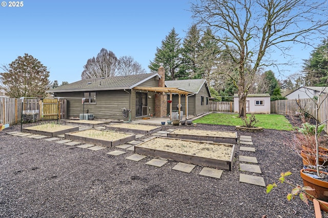 back of house with a lawn, a patio, and a storage shed