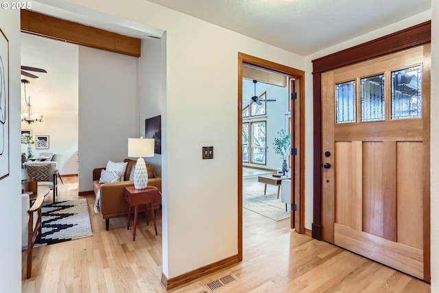 entrance foyer featuring a notable chandelier and light hardwood / wood-style flooring