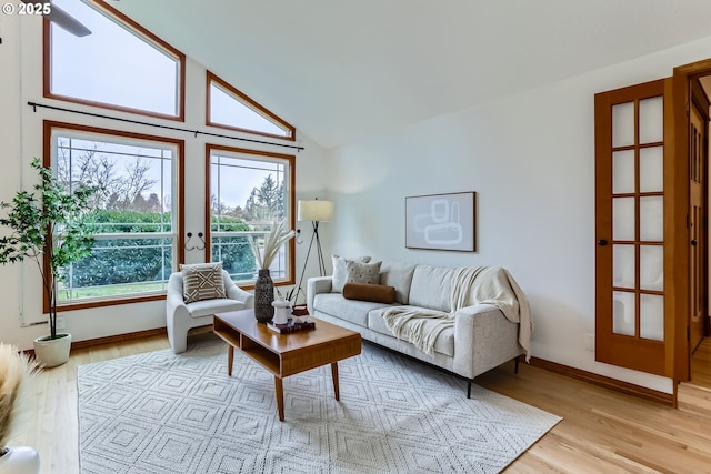 living room featuring light wood-type flooring and lofted ceiling