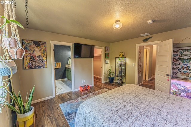 9511 NE 73rd St, Vancouver, WA 98662 - bedroom with wood finished floors, a spacious closet, a textured ceiling, ensuite bath, and a closet