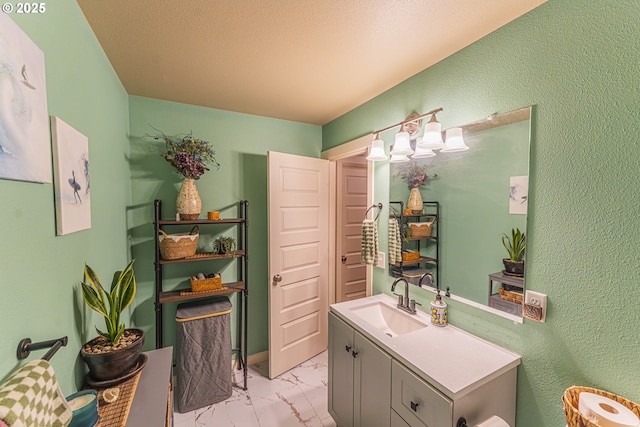 9511 NE 73rd St, Vancouver, WA 98662 - bathroom with vanity, marble look tiles, and a textured wall