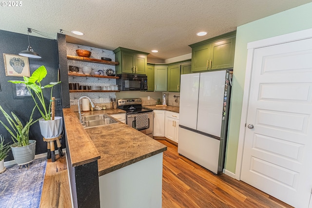 9511 NE 73rd St, Vancouver, WA 98662 - kitchen featuring green cabinets, freestanding refrigerator, electric range, black microwave, and dark wood-style flooring