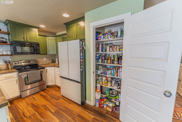 9511 NE 73rd St, Vancouver, WA 98662 - kitchen with black microwave, freestanding refrigerator, green cabinets, stainless steel electric range oven, and dark wood-style floors
