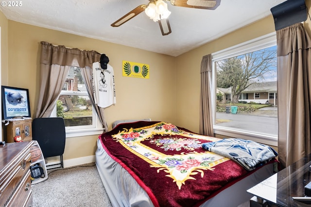 carpeted bedroom featuring ceiling fan