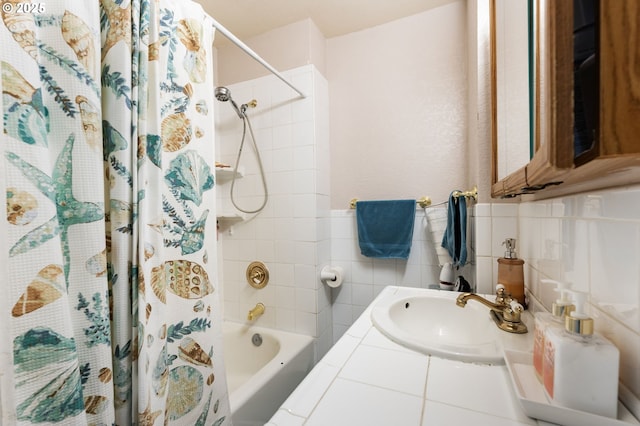 bathroom featuring sink, tile walls, and shower / tub combo with curtain