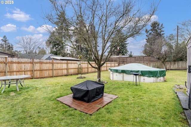 view of yard with a covered pool