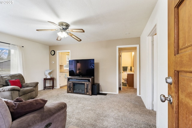 carpeted living room featuring ceiling fan