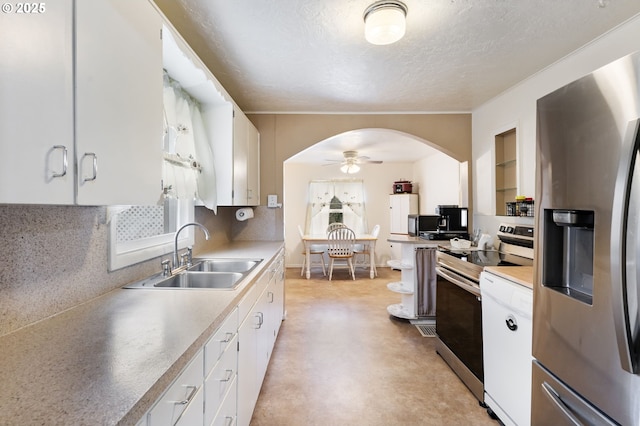 kitchen featuring stainless steel appliances, sink, white cabinets, and a textured ceiling