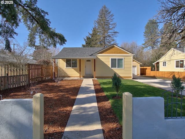 bungalow-style house with a front yard, roof with shingles, and fence