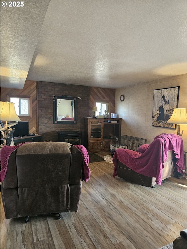 living room featuring a wealth of natural light, wood walls, and light wood-type flooring