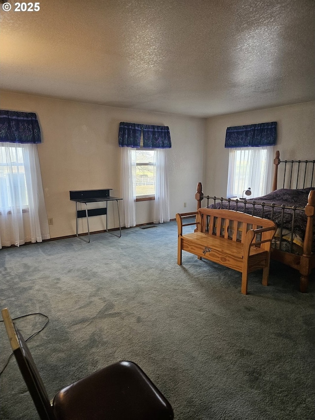 carpeted bedroom featuring a textured ceiling