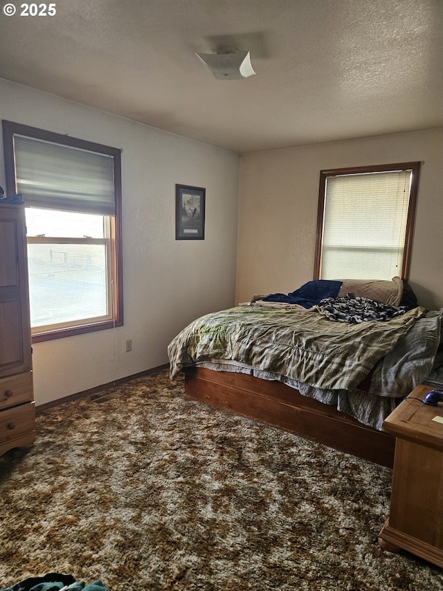 bedroom with carpet flooring and a textured ceiling